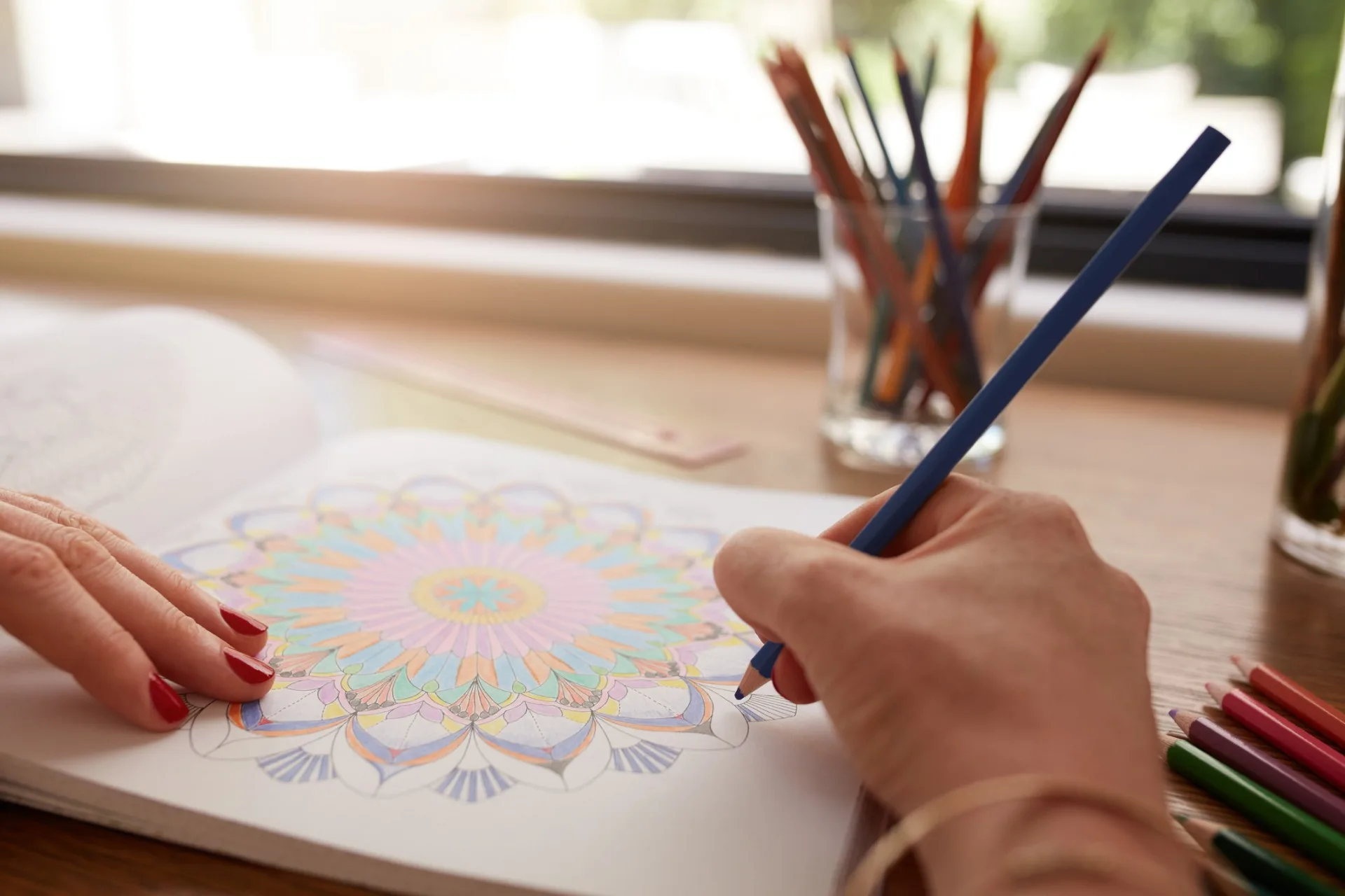 woman's hands coloring book mandala